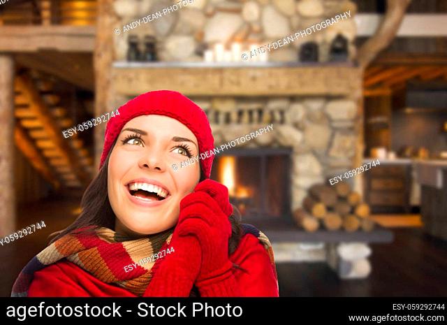 Smiling, Comfortable Mixed Race Girl Looking To The Side Enjoying Warm Fireplace In Rustic Cabin