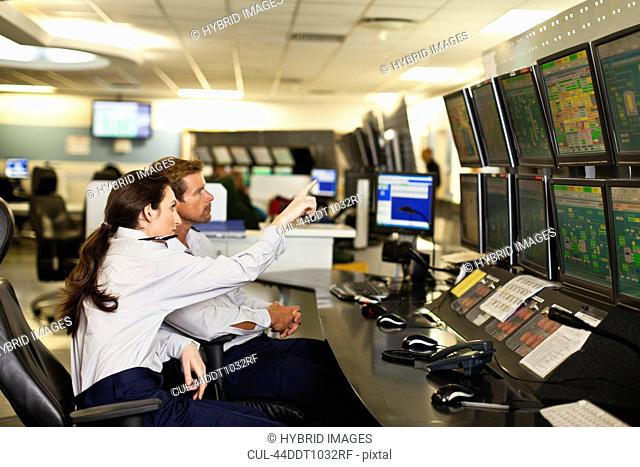 People working in security control room