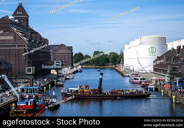 03 September 2023, Berlin: Visitors ride a steamboat across the harbor basin at the celebration of the 100th anniversary of BEHALA, Berlin's western harbor