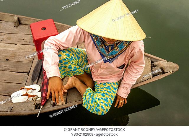 A Local Woman Wait For Tourists To Take Out On River Boat Trips, Hoi An, Quang Nam Province, Vietnam