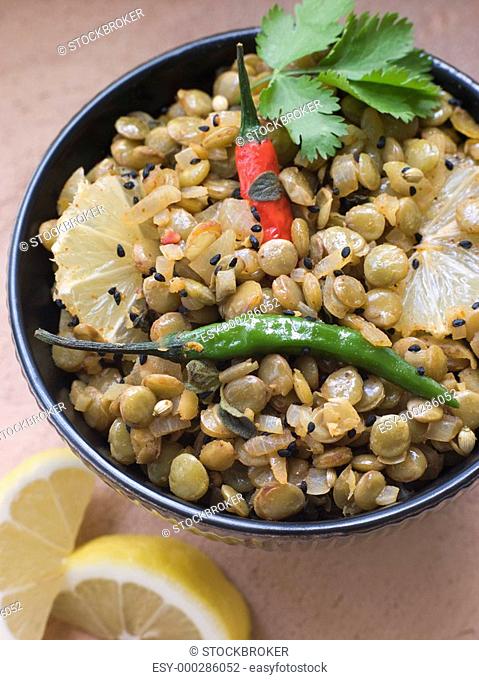 Bowl of Green Lentils cooked with Sliced Lemon Chili and Coriander
