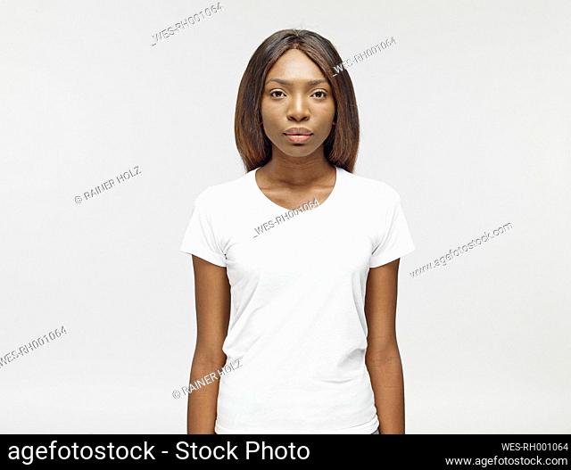 Portrait of serious looking young woman wearing white t-shirt