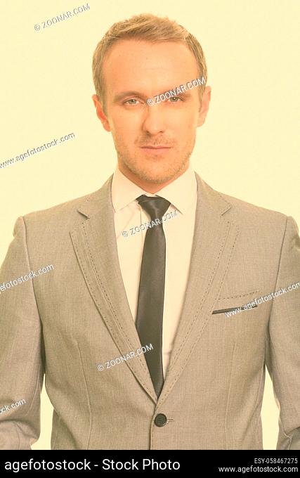 Studio shot of handsome businessman with blond hair in suit isolated against white background