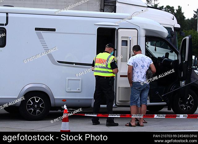 03 July 2021, Thuringia, Hermsdorf: Police officers check a motor home in a parking lot on highway 9. With the start of the holiday travel season