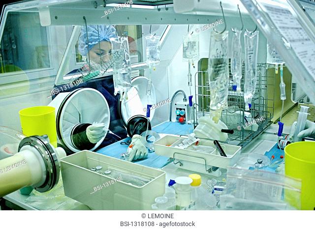 Photo essay from hospital. Rambouillet hospital. Pharmacy. Preparation of drip pouches of chemotherapy in a sterile isolator or bubble by an assistant