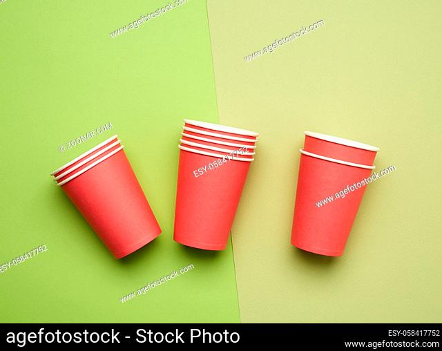 stack of red paper disposable cups on a blue background, flat lay, concept eco-friendly, zero waste