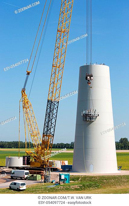 Dutch workers busy with the construction of a big new windturbine