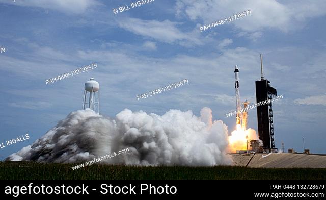 In this photo released by the National Aeronautics and Space Administration (NASA), a SpaceX Falcon 9 rocket carrying the company's Crew Dragon spacecraft is...