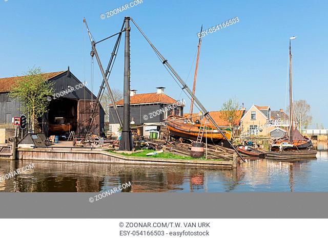 Historical ships at shipyard with slipway in harbor Dutch fishing village Workum