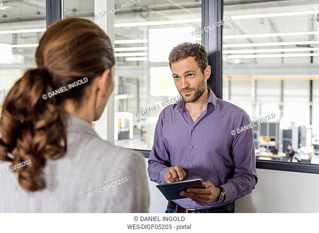 Businessman and woman having a meeting in company office