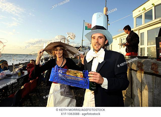 Two people in fancy dress at the annual al fresco dinner on the beach, Borth village, Ceredigion Wales ULK