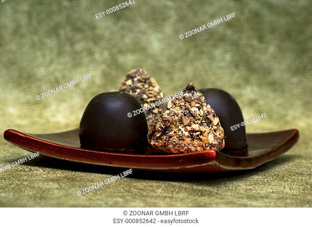 chocolate sweets on red plate