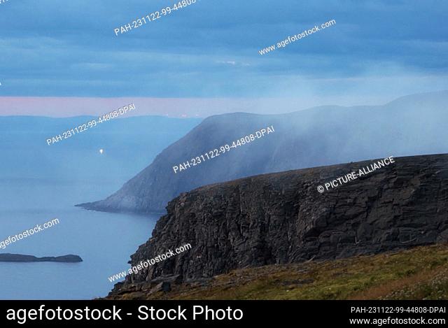 24 August 2023, Norway, Nordkapp: Rocks and cliffs near the North Cape Horn, taken in the early morning from the shale plateau of the North Cape