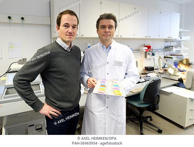 EMBARGO 11 February 2013 06:00 PM - Professor Thorsten Schlomm (R) and Joachim Weischenfeldt discuss tissue samples at the Martini Clinic at the University...