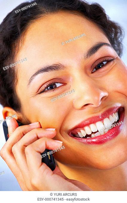 Talking business over the phone and smiling