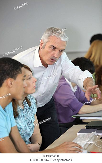 Teacher pointing to computer screen
