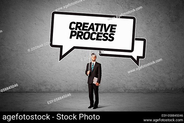 Young business person in casual holding road sign with CREATIVE PROCESS inscription, new business idea concept