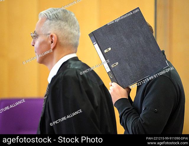 15 December 2022, Brandenburg, Neuruppin: The defendant (r) stands next to his defense attorney Morad Sehouli (l) at the beginning of the trial day in the...
