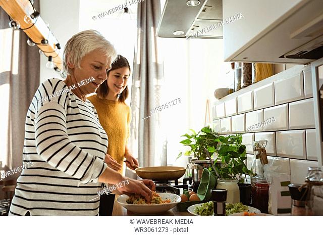 Senior woman and daughter preparing salad