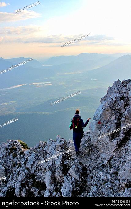 young woman descending from the upper, upper wettersteinspitze, 2.297m germany, bavaria, upper bavaria, werdenfelser land, mittenwald, isar valley