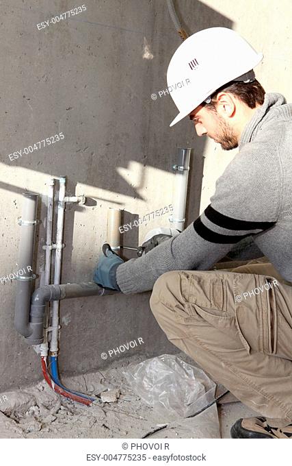 Plumber repairing water supply