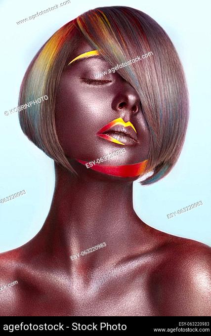 Beautiful girl with multi-colored hair and creative make up and hairstyle. Beauty face. Photo taken in the studio
