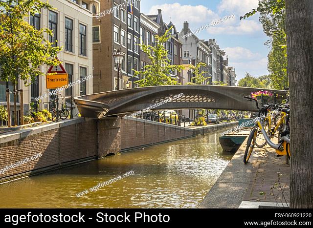 Netherlands. Summer day in Amsterdam. Bridge over a canal printed on a 3D printer. Sign that reads ""pedestrians only"" in Dutch