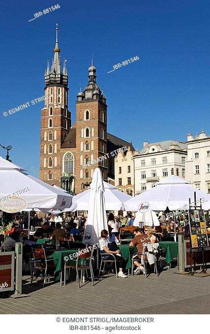 Street cafe and St Mary's church on Krakow Market Square, Rynek, UNESCO World Heritage Site, Poland, Europe