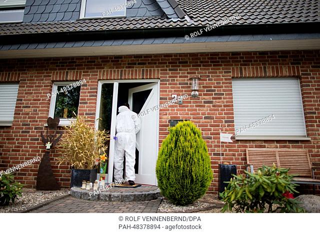A forensic officers enters a residential home in Steinfurt-Borghorst, Germany, 06 May 2014. Three children were found in the house