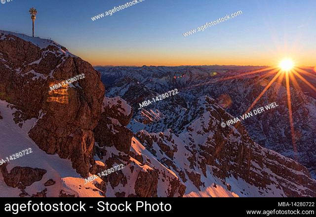 Morning mood on the Zugspitze, sunrise on Germany's highest mountain Top of Germany, sun star in the backlight. Mieminger chain