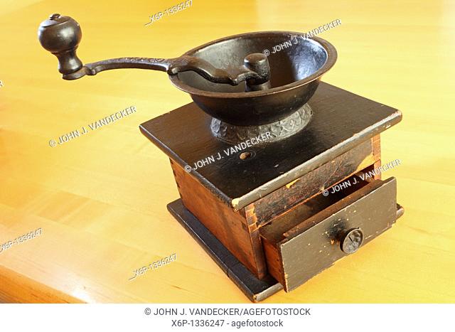 Still-life of an antique hand cranked tabletop coffee grinder  Manufactured by the C P  Co  the grinder dates back to the late 19th or early 20th century