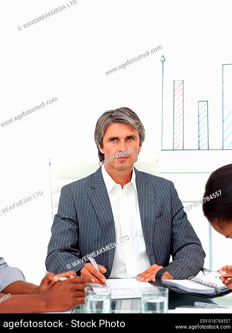 Charismatic mature businessman in a meeting