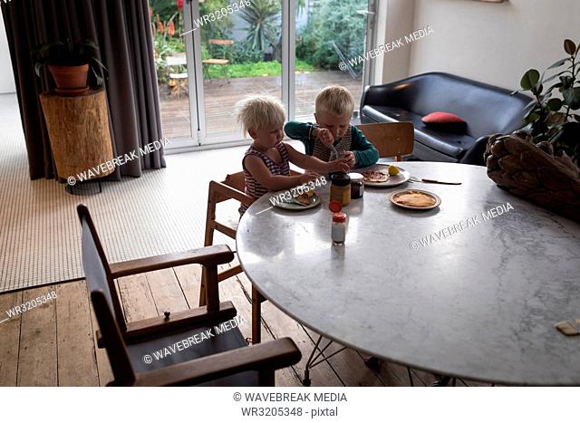 Kids having breakfast in living room