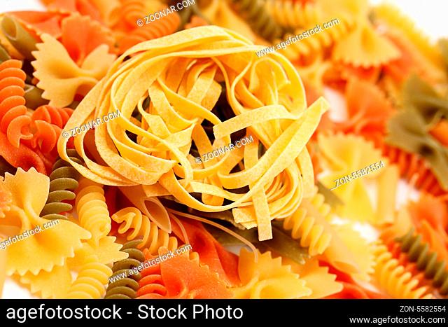 Different pasta in three colors. Close-up. Background