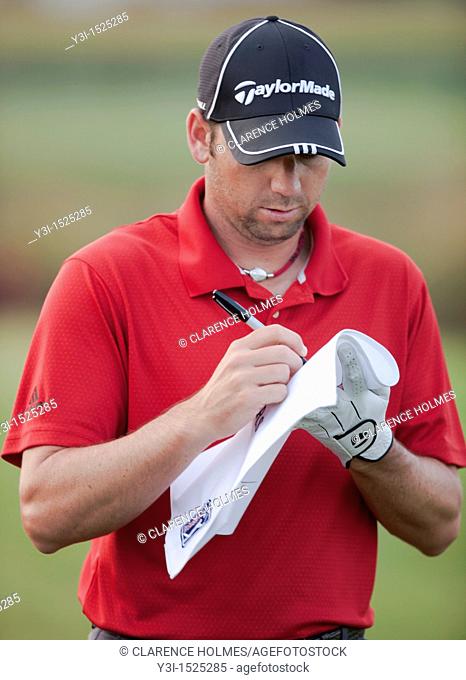 Defending champion Sergio Garcia signs an autograph on the practice tee prior to his practice round on Wednesday, May 6, 2009 for the Players Championship