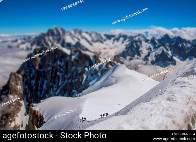 Snowy peaks and mountaineers in a sunny day, viewed from the Aiguille du Midi, near Chamonix. A famous ski resort located in Haute-Savoie Province in the French...