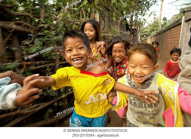 Young children run through a small village near Battambang, Cambodia