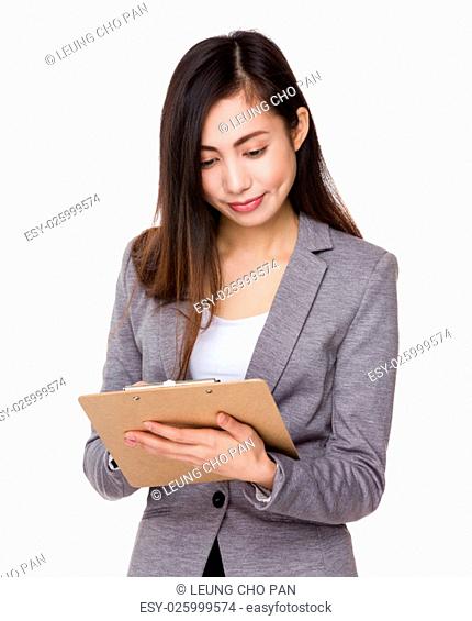 Young businesswoman take note on clipboard