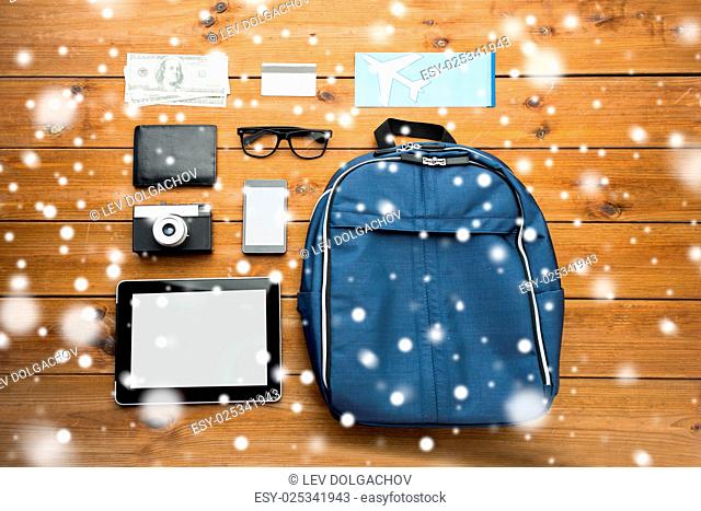 travel, tourism, winter holidays and objects concept - close up of smartphone with tablet pc computer, airplane ticket and personal stuff