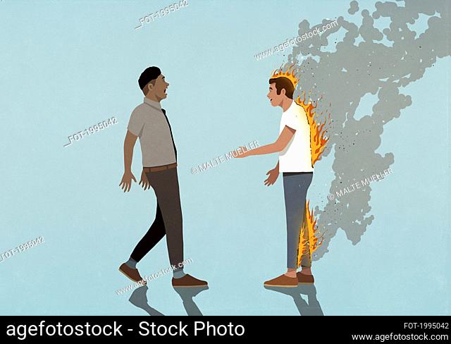 Alarmed businessman watching oblivious man on fire