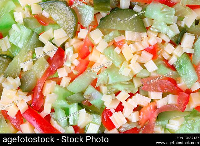 Salad of chopped vegetables and cheese background. Studio macro shot