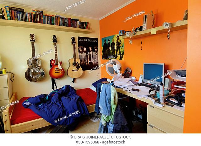An untidy and brightly coloured teenager's bedroom