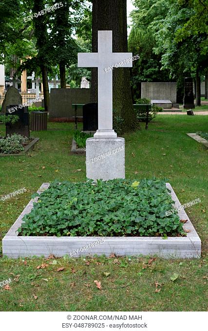 gravestone, stone cross on cemetery / graveyard