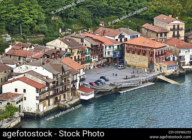 View of the fishing village along with its waterfront and boats in Pasai Donibane, Gipuzkoa, Basque Country, Spain