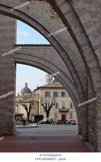 View of Piazza of Santa Chiara, Assisi, looking through lateral flying buttresses of the church
