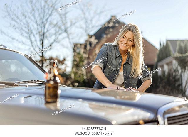 Woman cleaning her car