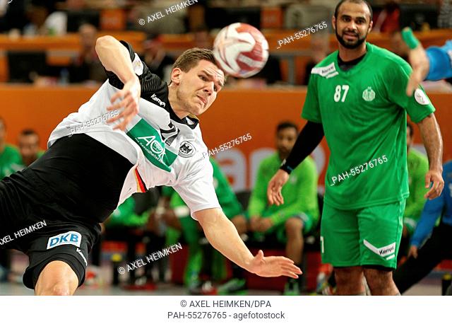 Germany's Erik Schmidt (L) throws beside Saudi Arabia's Mohammed Alzaer during the men's Handball World Championship 2015 Group D match between Germany and...