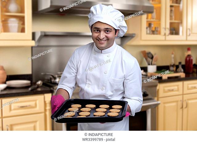 Chef with a tray of baked cookies