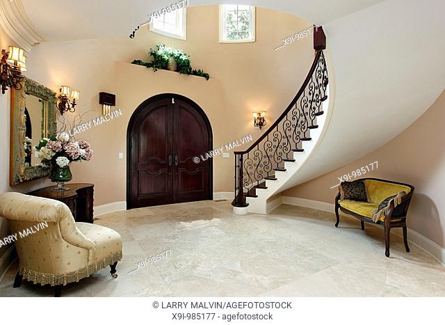 Foyer in luxury home with curved staircase