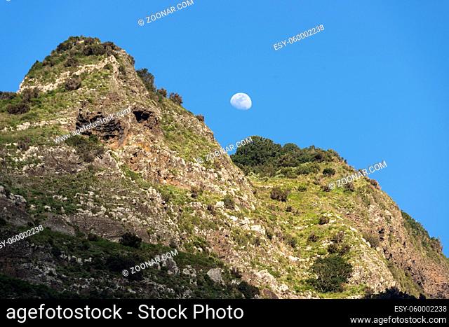 mounatain peakes on Madeira with blue sky and moon as background